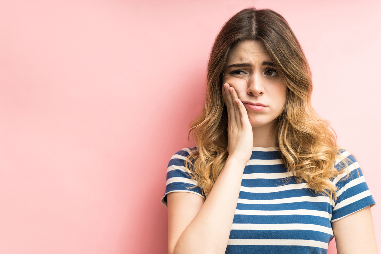 A young woman fighting a toothache
