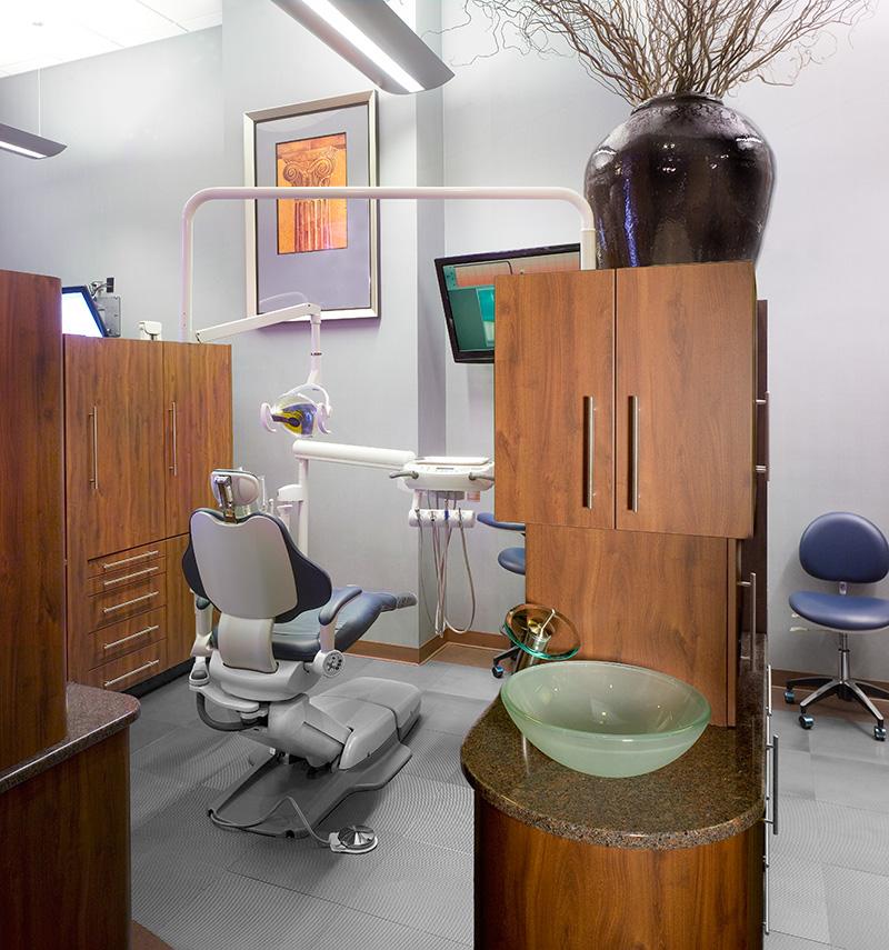 Dental chair in front of large screen tv where kids can watch movies during their visit